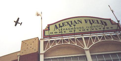 Photo of plane flying over ballpark